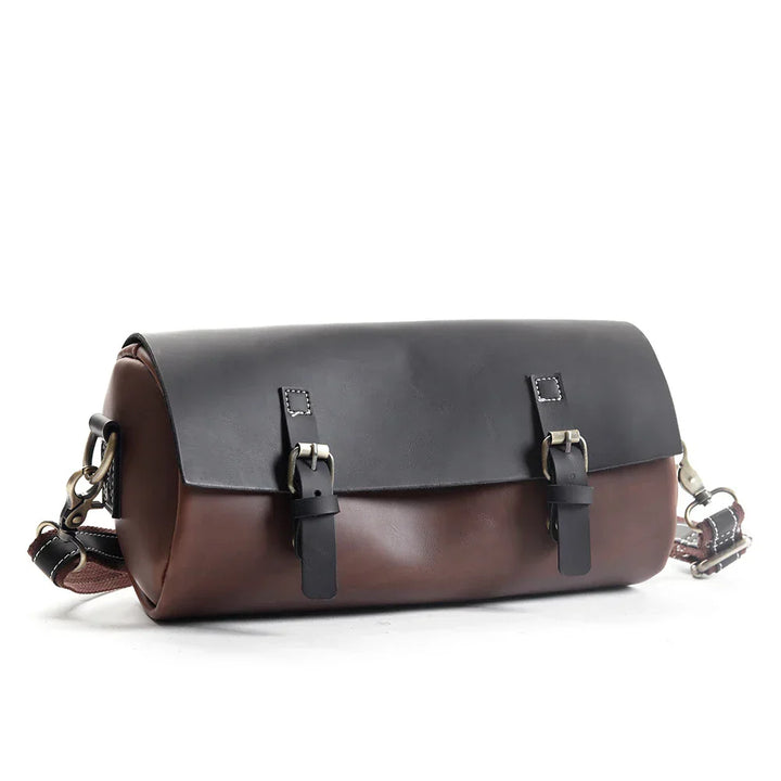 Borsa a tracolla in pelle marrone e nera, design elegante con fibbie metalliche, ideale per uomo e donna. Accessorio moda di alta qualità.