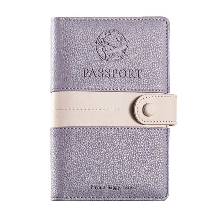 Custodia passaporto in pelle viola con chiusura a bottone beige, design elegante con incisione aereo, ideale per viaggiatori.