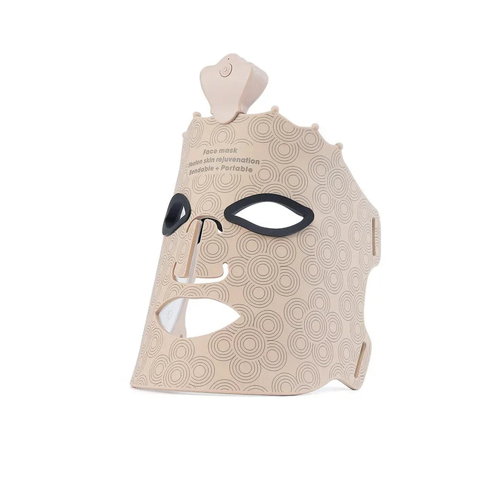 Maschera LED per terapia facciale, design beige con motivi circolari, fori per occhi e bocca, dispositivo portatile per cura della pelle e ringiovanimento.