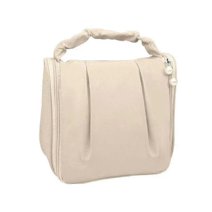 Borsa cosmetica beige con manico intrecciato, chiusura a zip, design elegante, ideale per viaggio, organizer trucco, accessori moda donna.