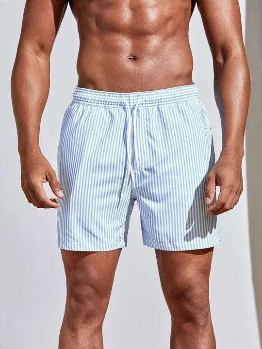 Uomo in costume da bagno a righe bianche e azzurre, elastico in vita, moda mare estiva, abbigliamento da spiaggia maschile, stile casual.