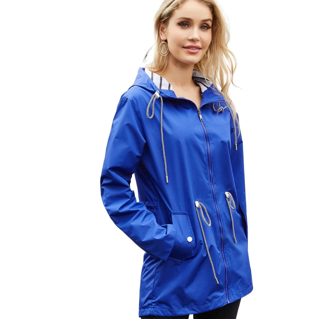 Giacca impermeabile donna blu con cappuccio, cerniera frontale e tasche. Moda casual, ideale per pioggia e outdoor. Disponibile in varie taglie.