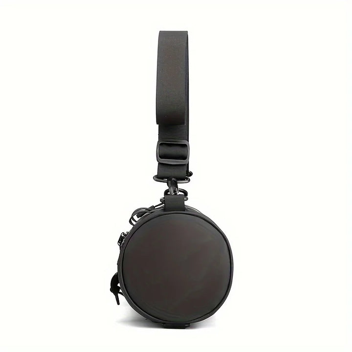 Borsa a tracolla rotonda nera unisex, design moderno, cinturino regolabile, chiusura con zip, ideale per moda urbana e viaggi.