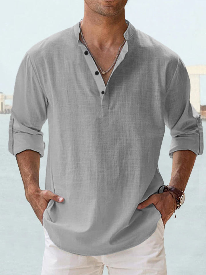 Camicia uomo lino grigia, maniche lunghe arrotolate, colletto alla coreana, abbottonatura parziale, stile casual estivo.