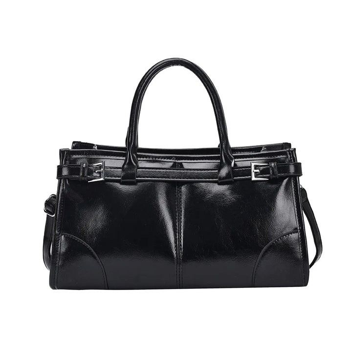 Borsa a mano in pelle nera lucida, design elegante con doppio manico e tracolla regolabile, ideale per moda donna e accessori di lusso.
