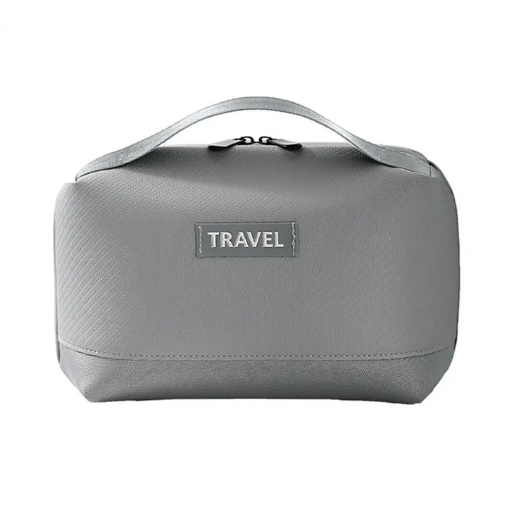 Borsa da viaggio grigia con manico, design compatto e chiusura a zip. Ideale per organizzare accessori e articoli da toeletta.