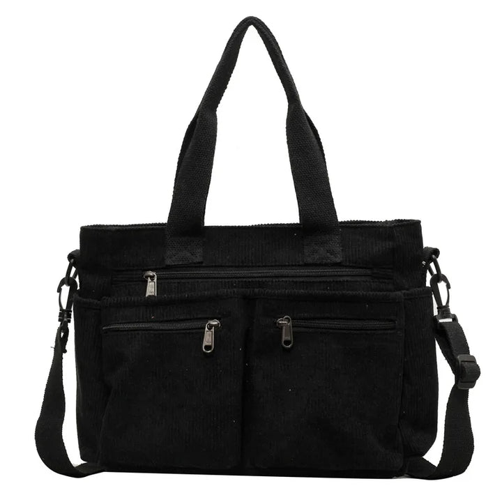 Borsa a tracolla nera in tessuto con manici, tasche frontali con cerniera e tracolla regolabile. Design elegante e funzionale per uso quotidiano.