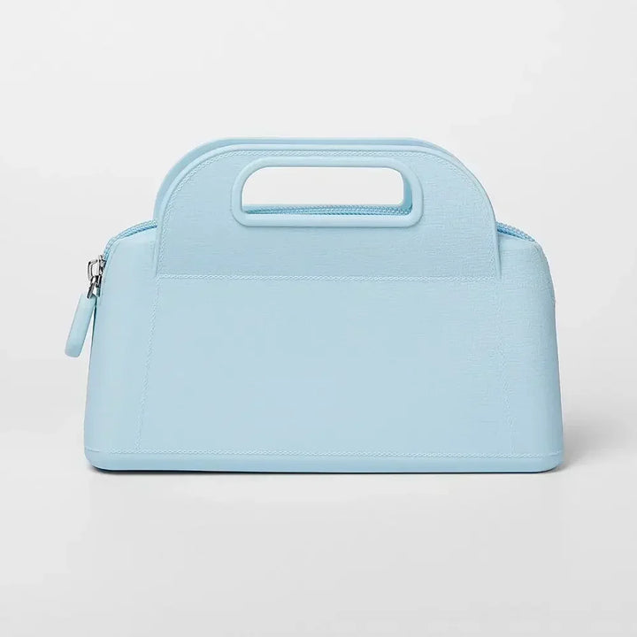 Borsa a mano in pelle azzurra con manico integrato, design elegante e moderno, ideale per moda femminile e accessori di lusso.
