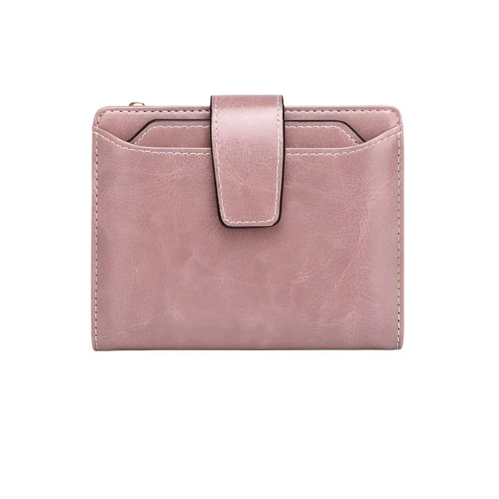 Portafoglio donna in pelle rosa con chiusura a bottone, design compatto e moderno, ideale per carte e contanti. Accessorio moda elegante.