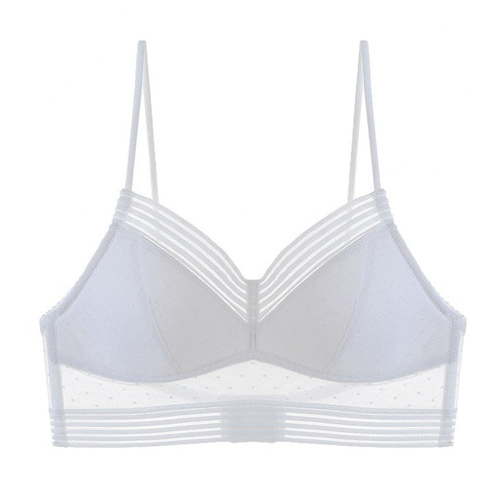 Reggiseno bianco trasparente con spalline sottili, design a righe e dettagli a pois. Intimo femminile elegante e moderno.