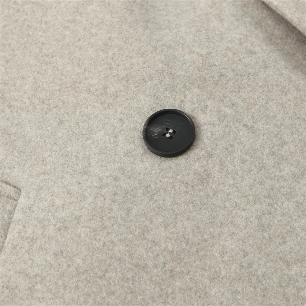 Cappotto in lana beige con bottone nero, tessuto morbido e caldo, ideale per l'inverno. Design elegante e versatile per uomo o donna.