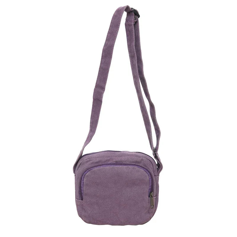 Borsa a tracolla viola in tessuto, design compatto, chiusura con zip, ideale per uso quotidiano. Accessorio moda donna, stile casual.
