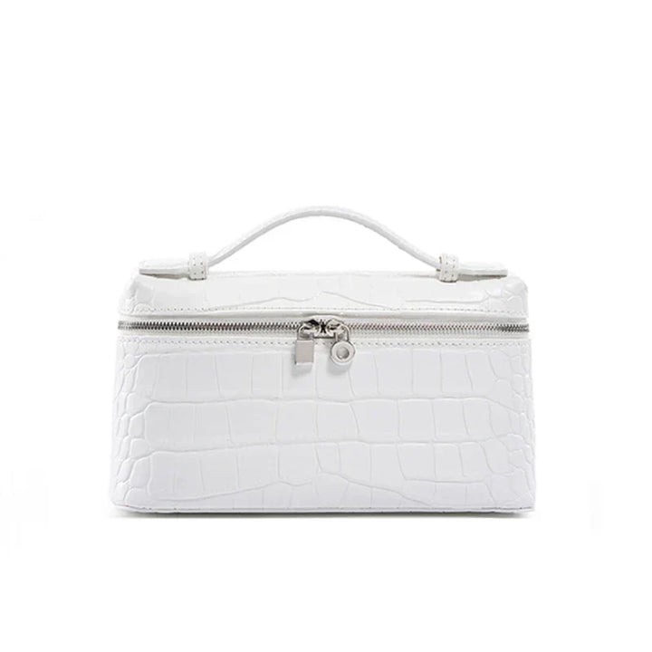 Borsa cosmetica bianca in pelle effetto coccodrillo con manico superiore e chiusura a zip. Elegante e pratica per viaggi e organizzazione.