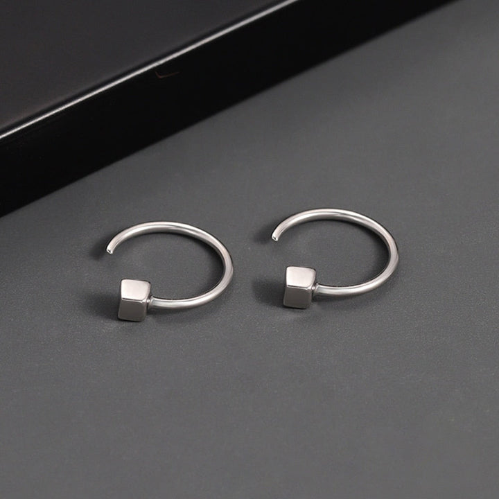 Orecchini a cerchio in argento con design minimalista e cubo geometrico, eleganti e moderni, ideali per moda donna e accessori gioielli.