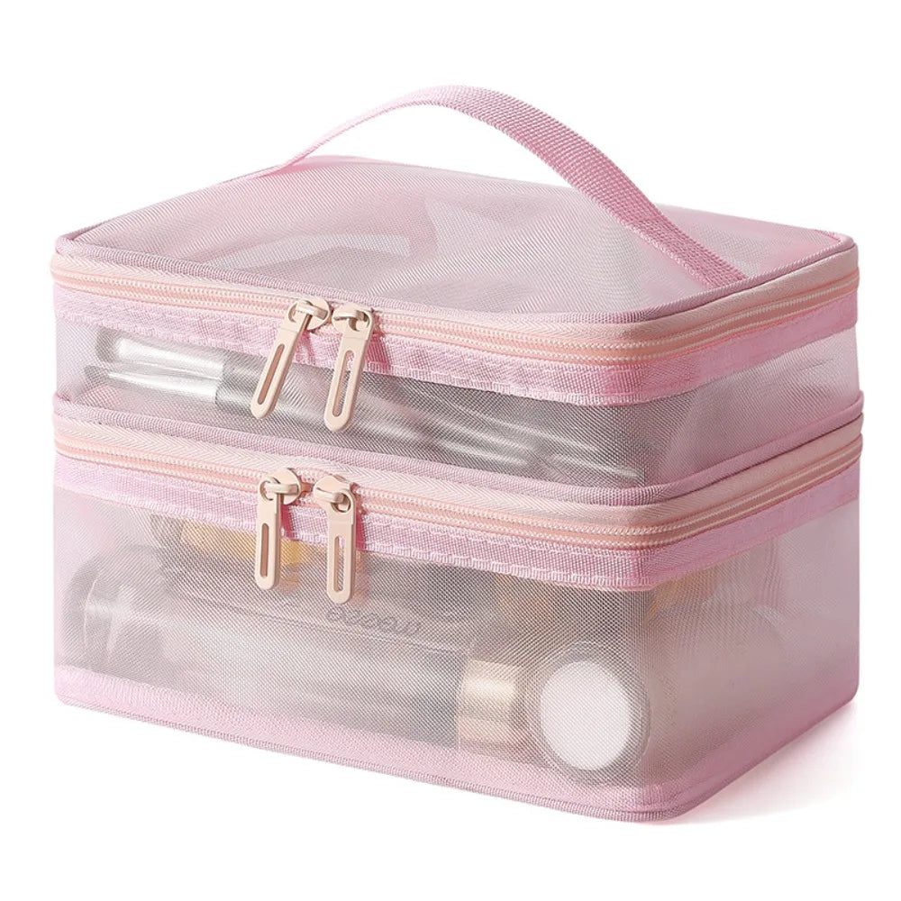 Borsa cosmetica trasparente rosa a due scomparti con cerniere, ideale per organizzare trucchi e accessori da viaggio.