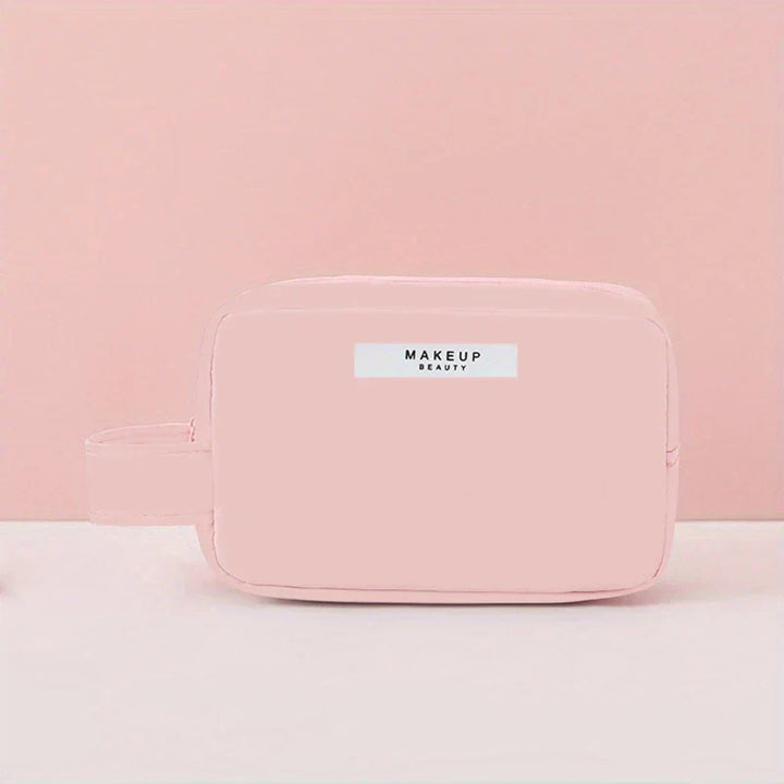 Astuccio trucco rosa pastello con cerniera, design minimalista, ideale per cosmetici e accessori da viaggio. Elegante e pratico per l'organizzazione.