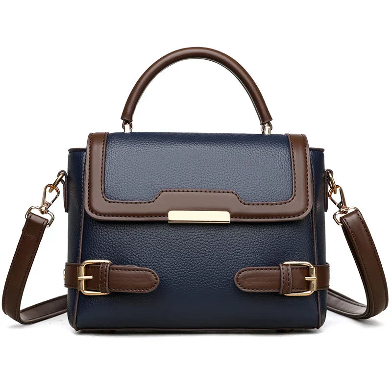Borsa a tracolla donna in pelle blu e marrone, design elegante con fibbie decorative, manico superiore e tracolla regolabile. Accessorio moda chic.