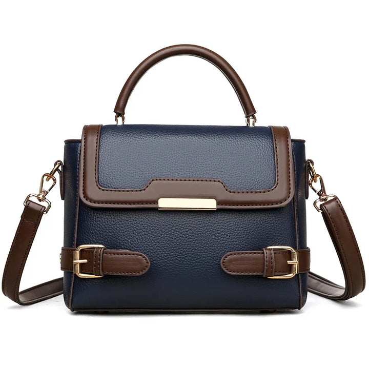 Borsa a tracolla donna in pelle blu e marrone, design elegante con fibbie decorative, manico superiore e tracolla regolabile. Accessorio moda chic.
