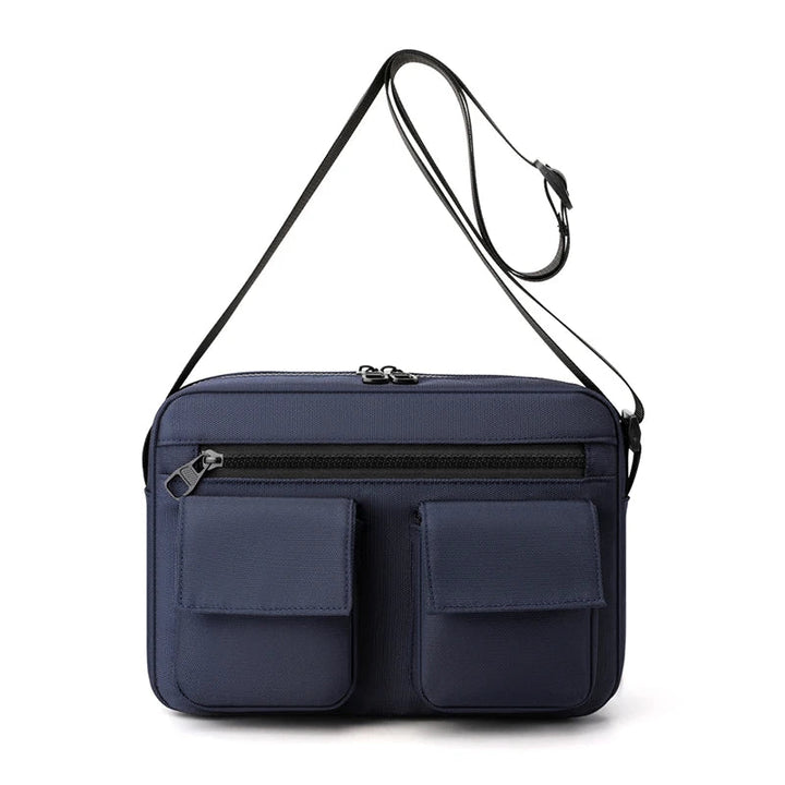 Borsa a tracolla blu scuro con doppia tasca frontale e cerniera, design elegante e funzionale, ideale per uomo e donna.