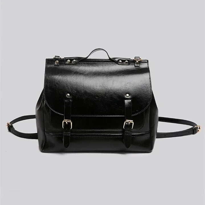 Zaino in pelle nera elegante con fibbie dorate, design classico, ideale per lavoro e viaggio. Accessorio moda unisex di alta qualità.