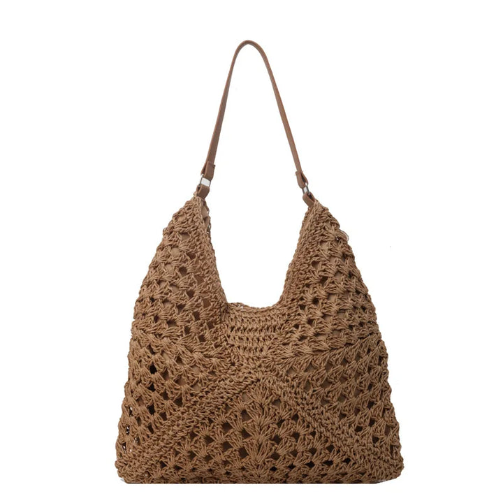 Borsa a spalla in paglia intrecciata marrone, design estivo, manico in pelle, stile boho chic, accessorio moda donna, capiente e leggero.
