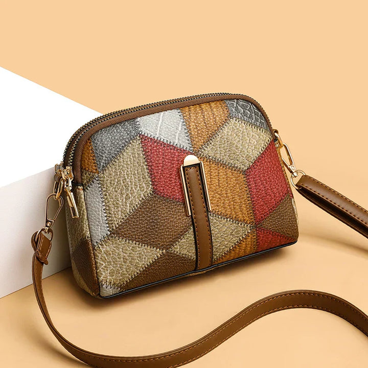 Borsa a tracolla donna in pelle patchwork multicolore, design geometrico, chiusura zip, elegante e moderna, perfetta per ogni occasione.
