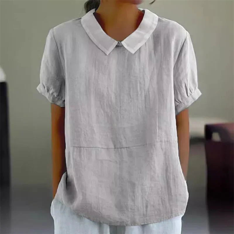 Camicia donna in lino grigio chiaro, maniche corte, colletto classico, stile casual elegante, perfetta per look estivi e primaverili.