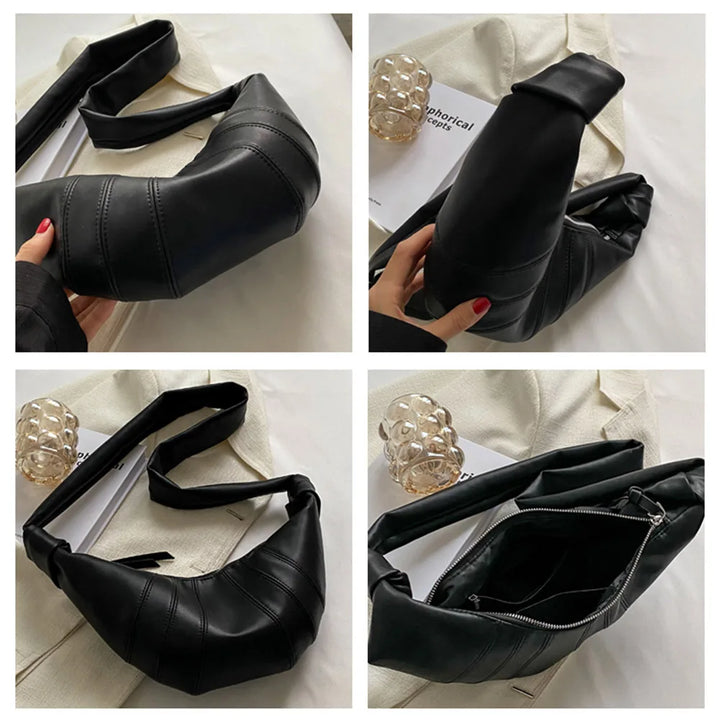 Borsa a tracolla nera in pelle, design moderno, chiusura con zip, dettagli cuciture, ideale per moda donna, accessorio elegante e versatile.