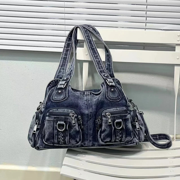 Borsa a spalla in denim blu scuro con tasche multiple e dettagli in metallo, design casual e versatile, perfetta per uso quotidiano e moda urbana.