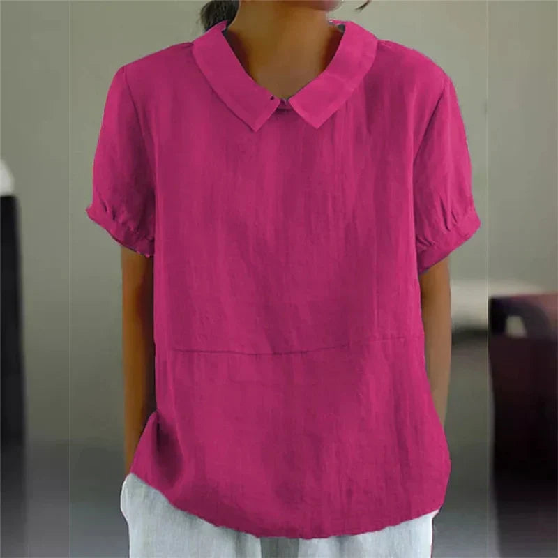 Blusa donna rosa fucsia, maniche corte, colletto classico, tessuto leggero, moda estiva casual, abbigliamento femminile elegante.