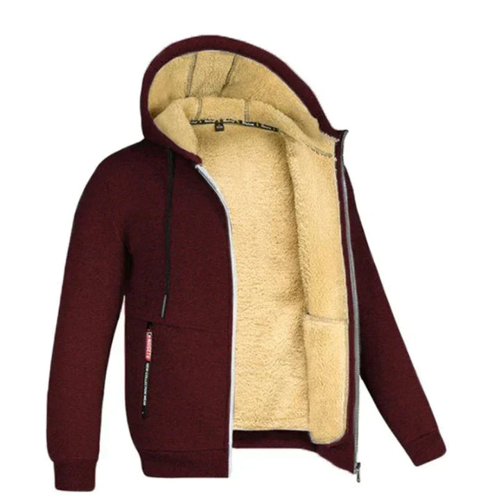 Giacca con cappuccio invernale bordeaux, interno in pelliccia sintetica beige, zip frontale, tasche laterali. Abbigliamento caldo e casual uomo.