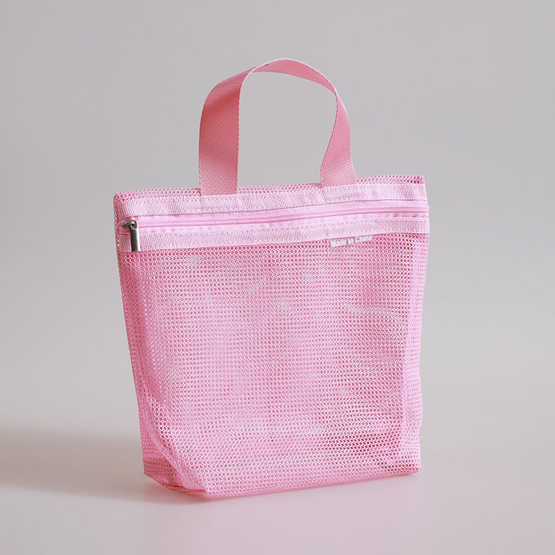 Borsa organizer rosa in rete con cerniera, ideale per viaggi e cosmetici. Design compatto e leggero, perfetto per organizzare accessori personali.