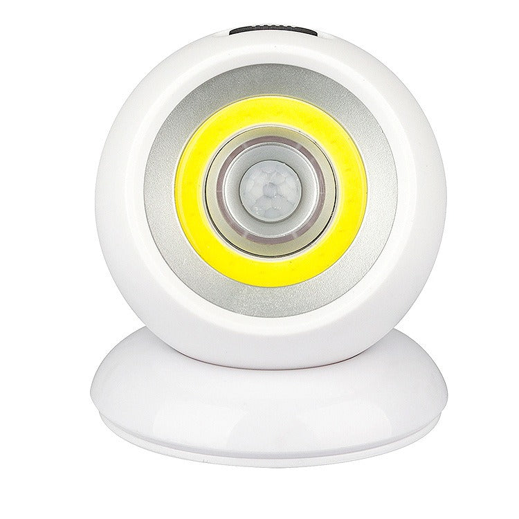 Lampada LED sensore di movimento, design circolare bianco, luce notturna automatica, ideale per interni, risparmio energetico, facile installazione.