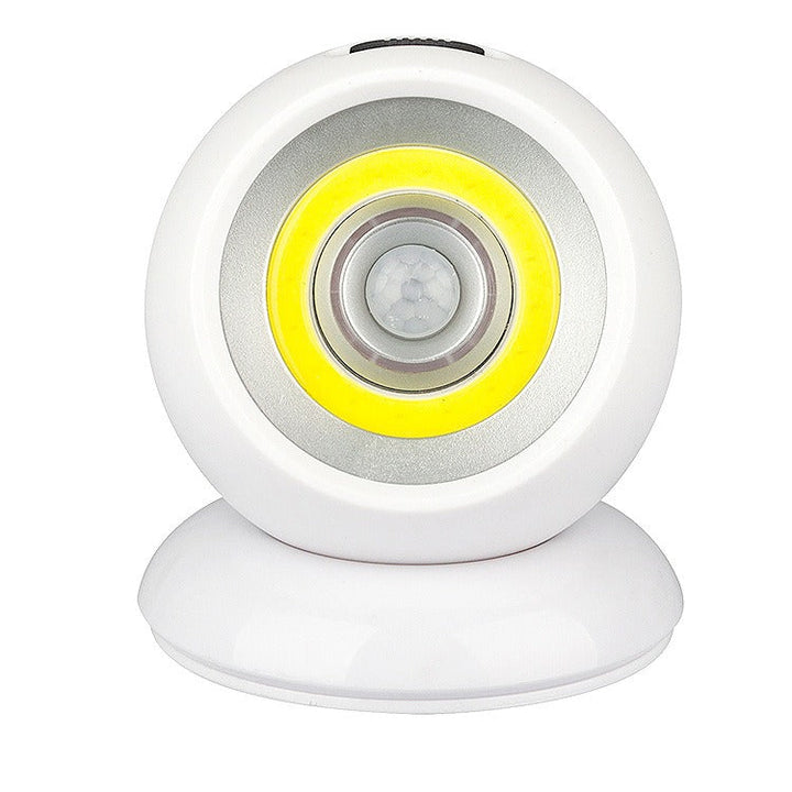 Lampada LED sensore di movimento, design circolare bianco, luce notturna automatica, ideale per interni, risparmio energetico, facile installazione.