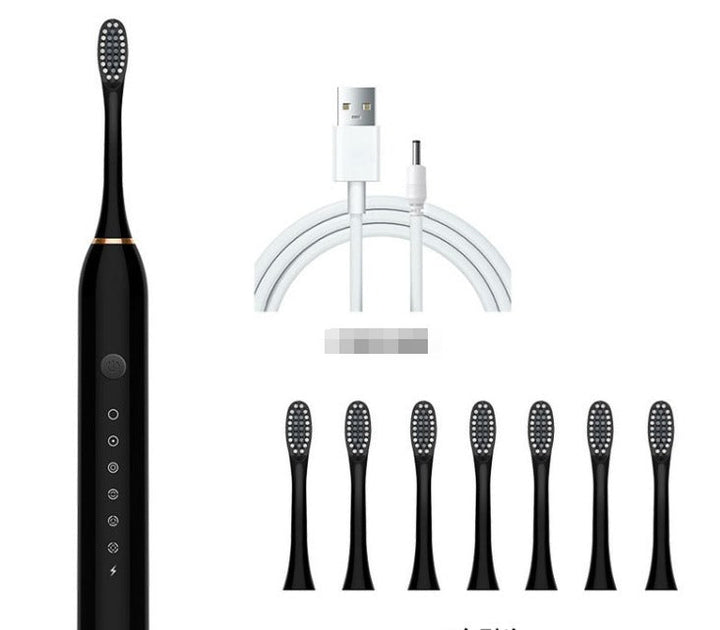 Spazzolino elettrico nero con setole intercambiabili, sei testine di ricambio e cavo di ricarica USB. Accessorio per igiene orale avanzata.