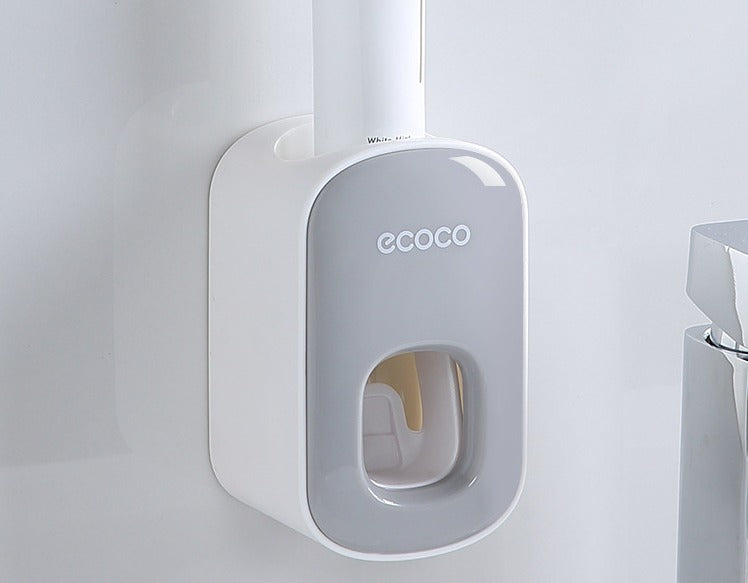 Dispenser automatico di dentifricio Ecoco montato a parete, design moderno bianco e grigio, ideale per bagno, accessorio pratico e igienico.