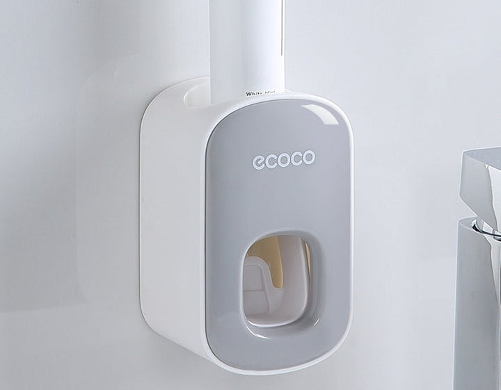 Dispenser automatico di dentifricio Ecoco montato a parete, design moderno bianco e grigio, ideale per bagno, accessorio pratico e igienico.