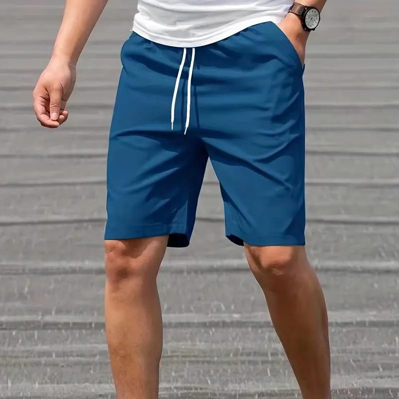 Pantaloncini sportivi blu da uomo con coulisse, tasche laterali, indossati con maglietta bianca. Ideali per attività sportive e tempo libero.