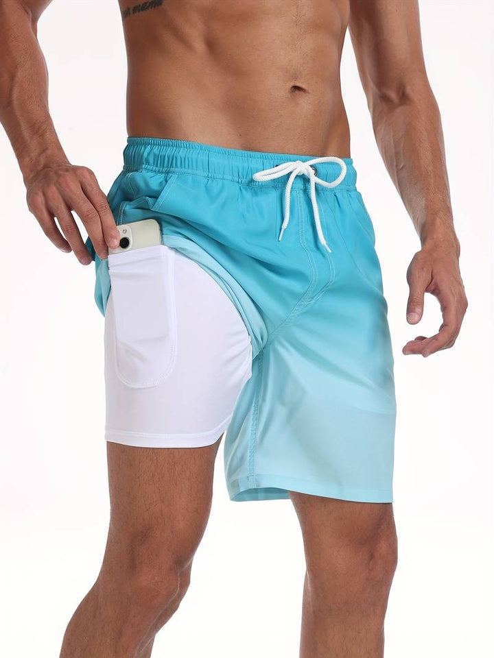 Costume da bagno uomo azzurro e bianco con tasca laterale per smartphone, design moderno, perfetto per nuoto e spiaggia.