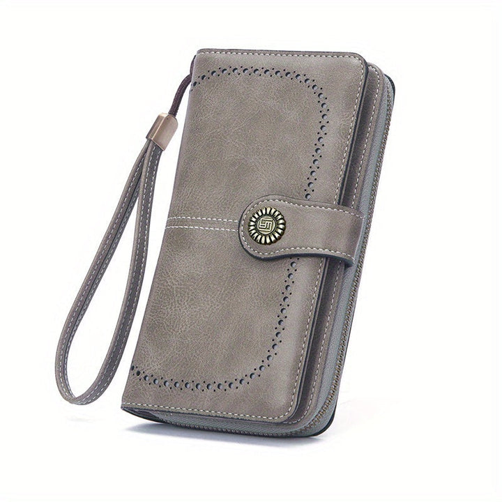 Portafoglio donna in pelle grigia con cinturino, design elegante con chiusura a bottone decorativa, ideale per moda e accessori femminili.