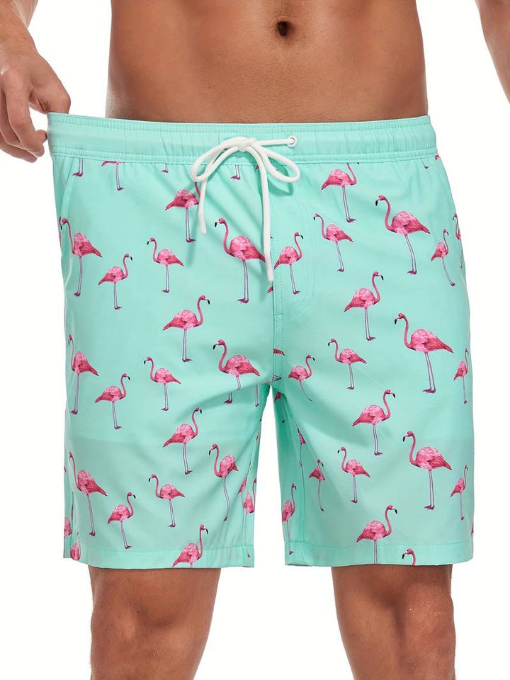 Costume da bagno uomo verde menta con stampa fenicotteri rosa, laccio in vita. Design estivo, moda mare, abbigliamento da spiaggia.