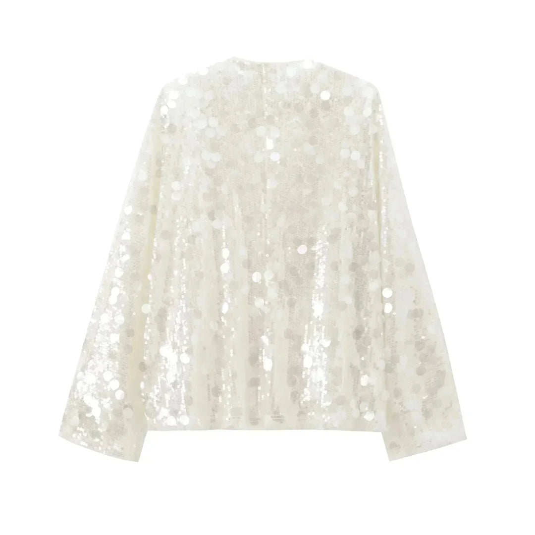 Blouse ivoire à paillettes avec col en V, en tissu léger, parfaite pour une tenue élégante et festive.
