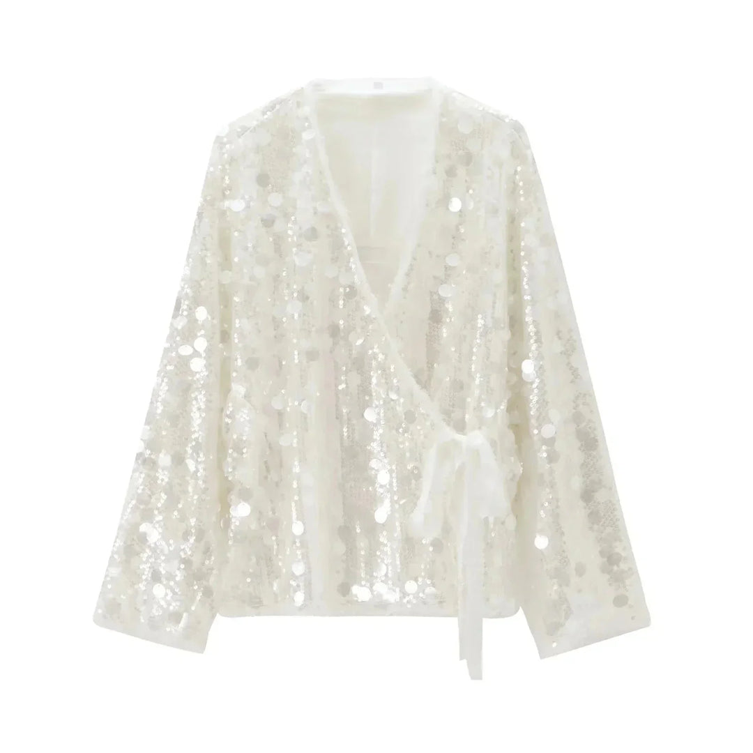 Blouse femme ivoire en tissu léger, paillettes scintillantes et col en V pour une touche d'élégance subtile.