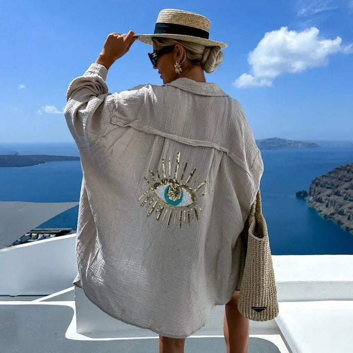 Blouse femme oversize kaki en coton, avec motif œil brodé sur le devant et des manches longues pour un style décontracté.