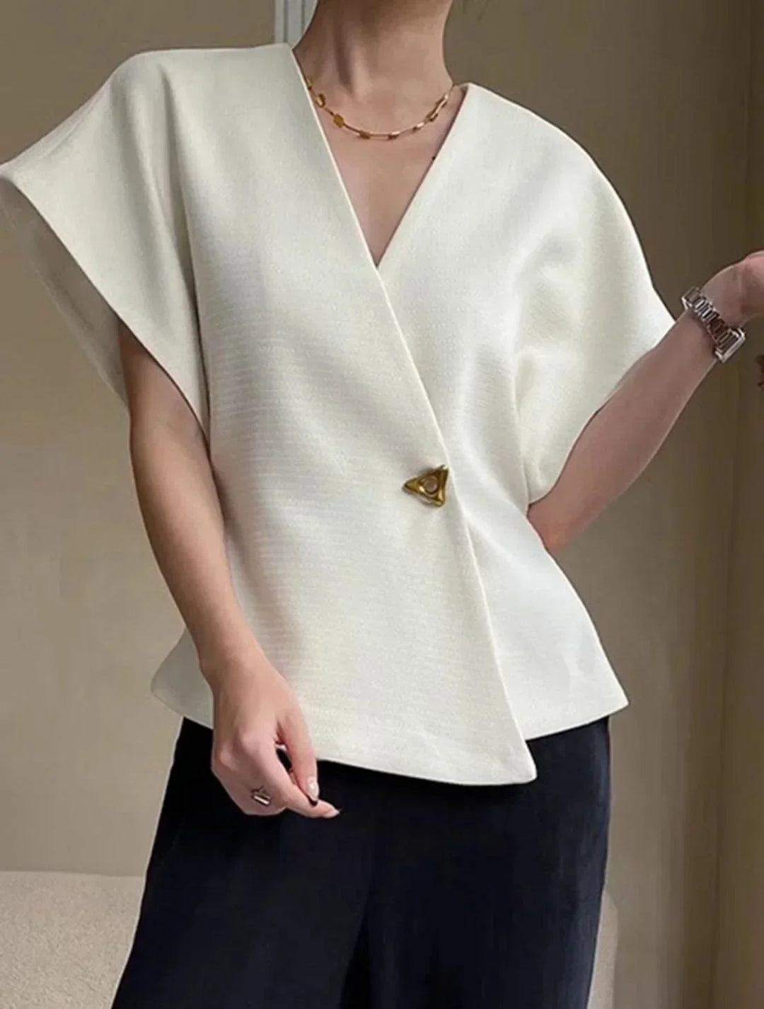 Blouse femme cache-cœur avec manches sculptées en tissu léger, idéale pour un look élégant et décontracté.
