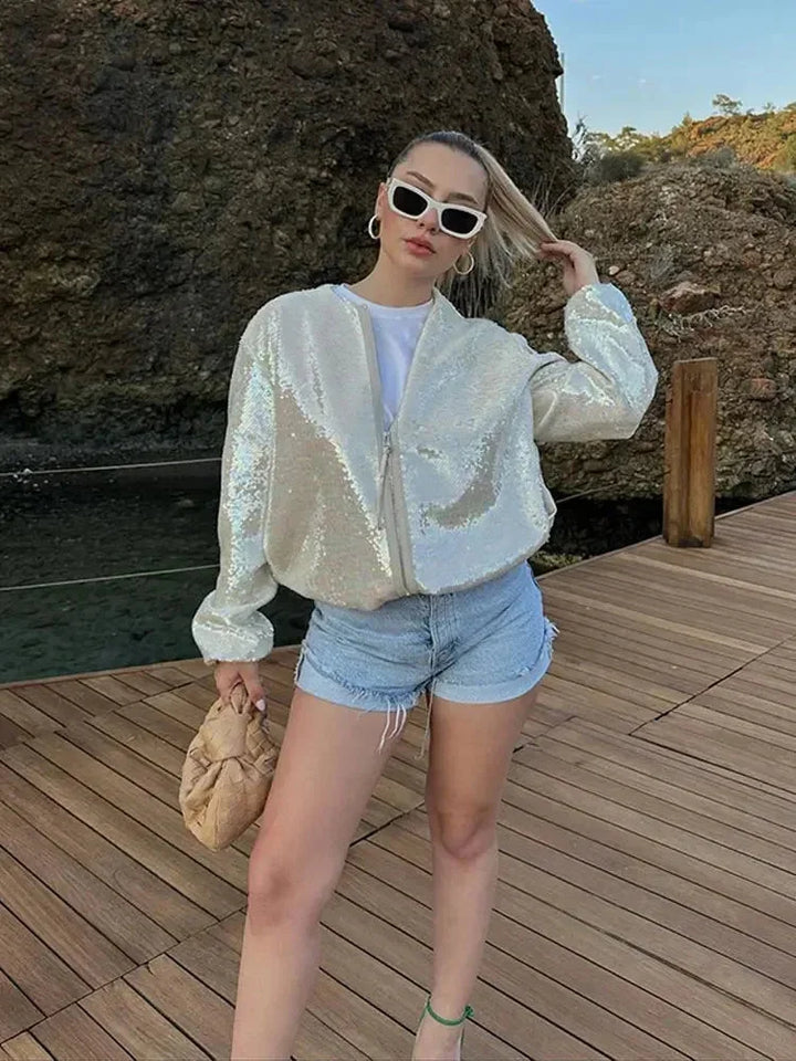 Ivory bomber jacket for women with sequins, zip closure, and a shimmering design, perfect for adding sparkle to any outfit.