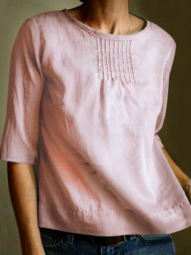 Blusa donna rosa in lino, maniche a tre quarti, scollo rotondo, dettagli pieghettati sul petto. Elegante e casual, perfetta per ogni occasione.