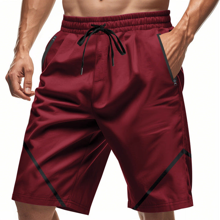 Pantaloncini sportivi uomo rossi, tasche laterali, coulisse regolabile, design moderno, tessuto traspirante, ideali per allenamento e fitness.
