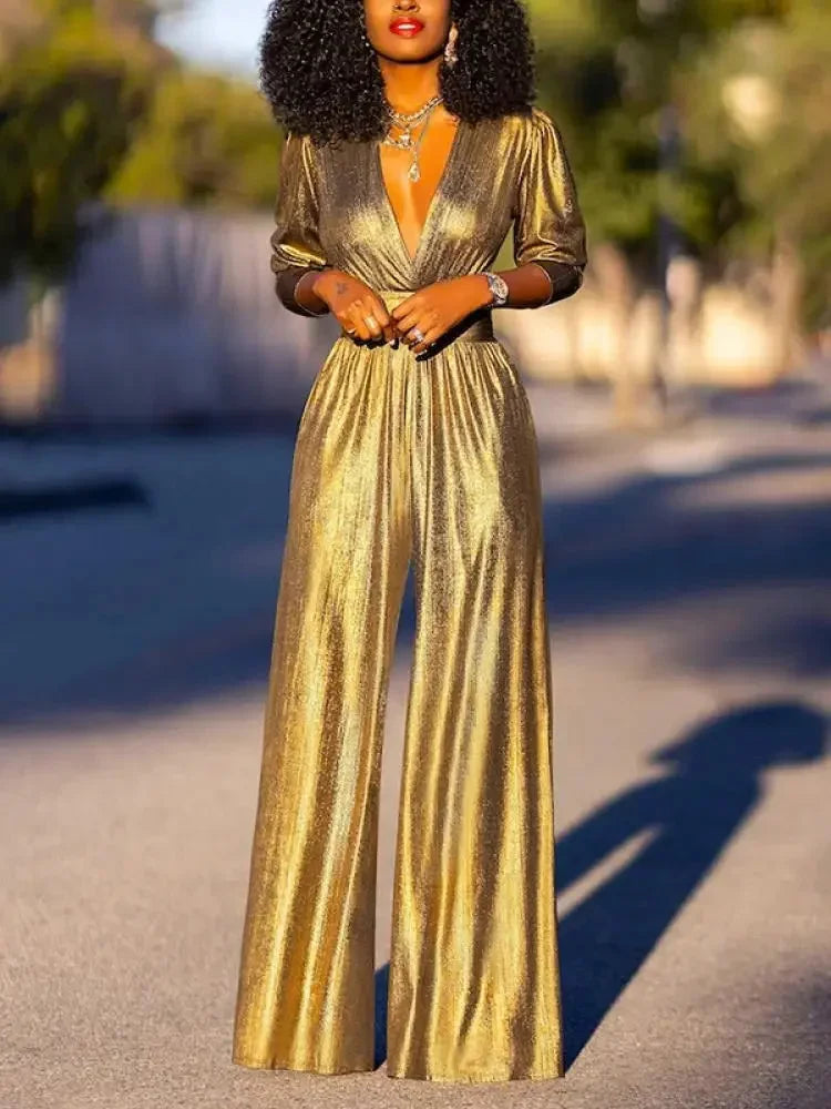 Combinaison femme à manches longues en satin brillant, couleur or, adaptée pour des occasions élégantes.