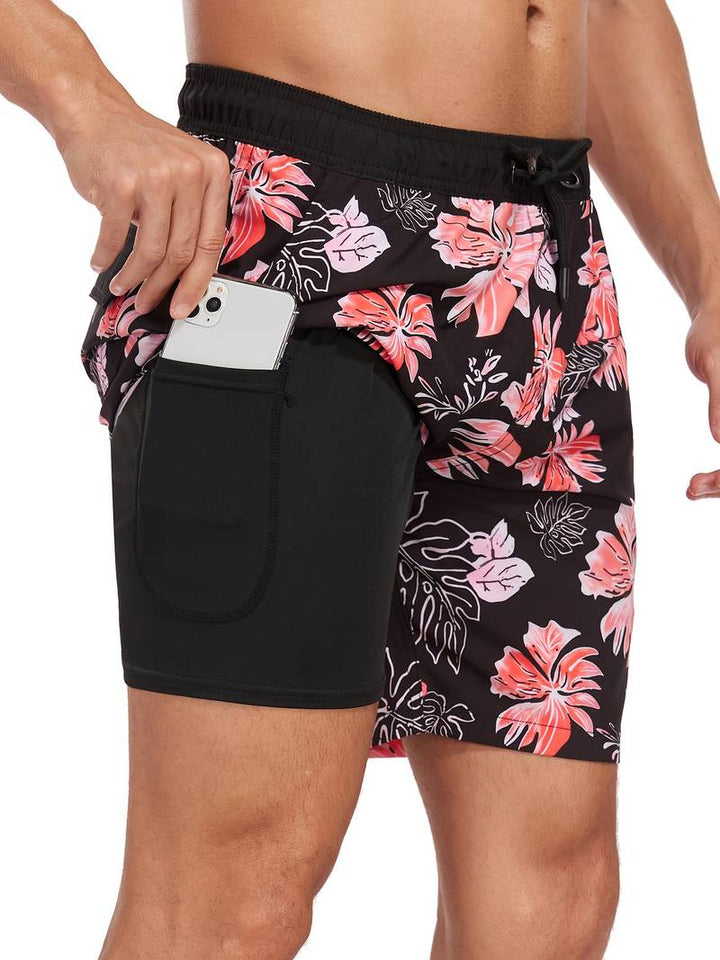Costume da bagno uomo nero con stampa floreale rosa, tasca laterale per smartphone. Design moderno, ideale per spiaggia e piscina.